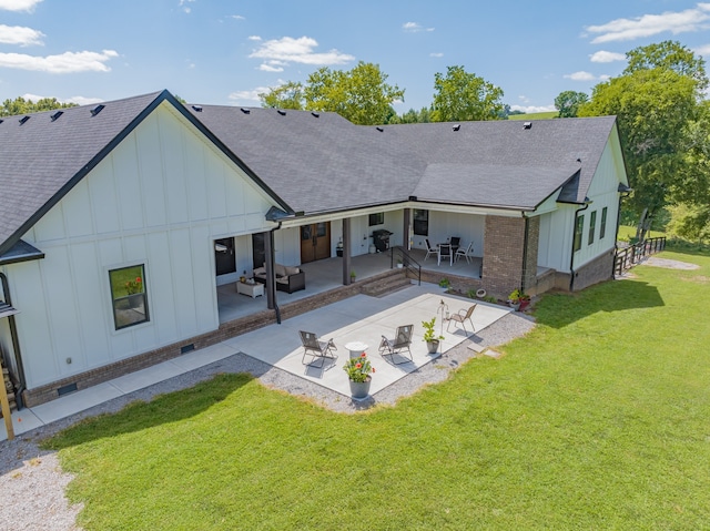 back of house featuring a lawn and a patio