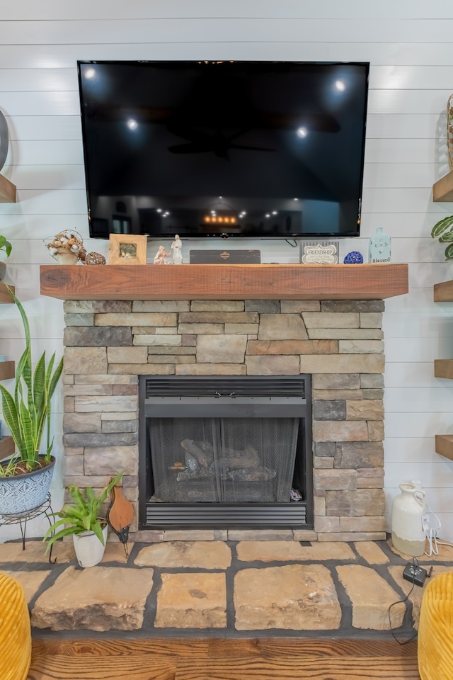 details featuring hardwood / wood-style floors and a stone fireplace