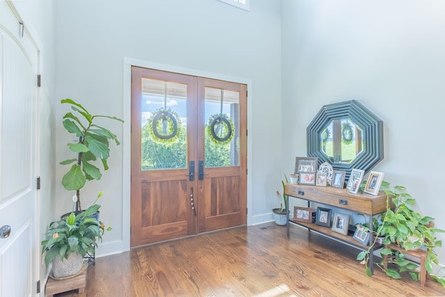 entrance foyer with plenty of natural light, french doors, and hardwood / wood-style flooring