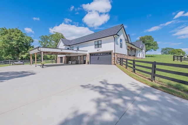 view of side of home with a garage, a yard, and a carport