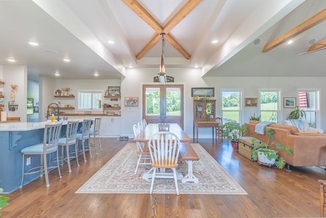 dining space with a healthy amount of sunlight, beamed ceiling, french doors, and dark wood-type flooring