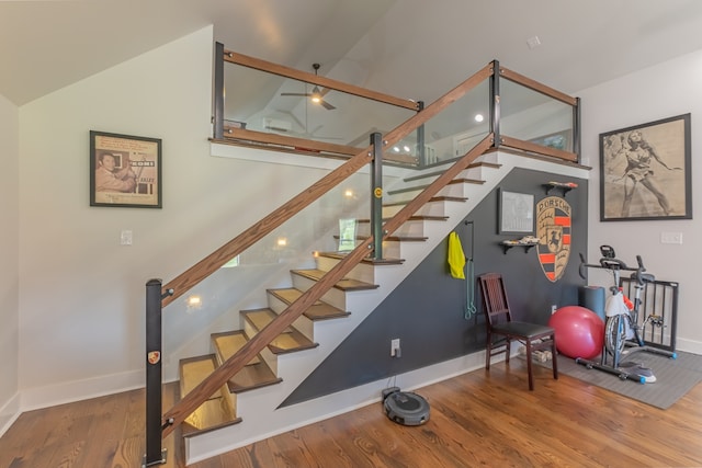 staircase with lofted ceiling and hardwood / wood-style flooring