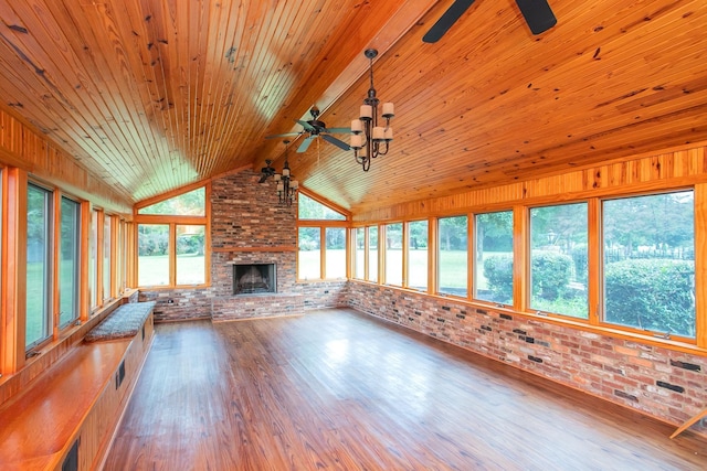 unfurnished living room with wood ceiling, brick wall, a fireplace, ceiling fan, and hardwood / wood-style flooring