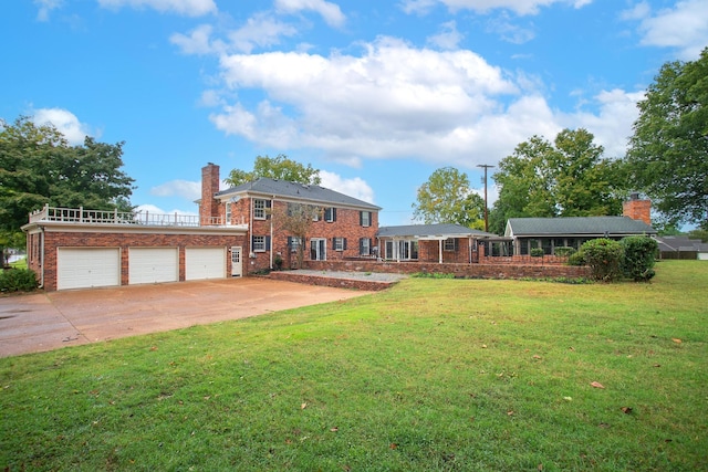 view of front of home with a garage and a front lawn