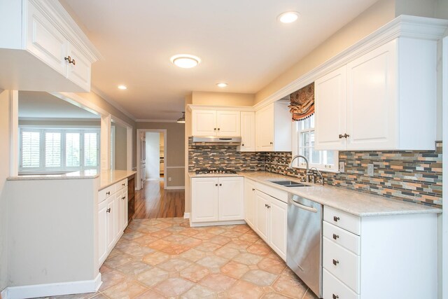 kitchen featuring stainless steel appliances, white cabinetry, and plenty of natural light