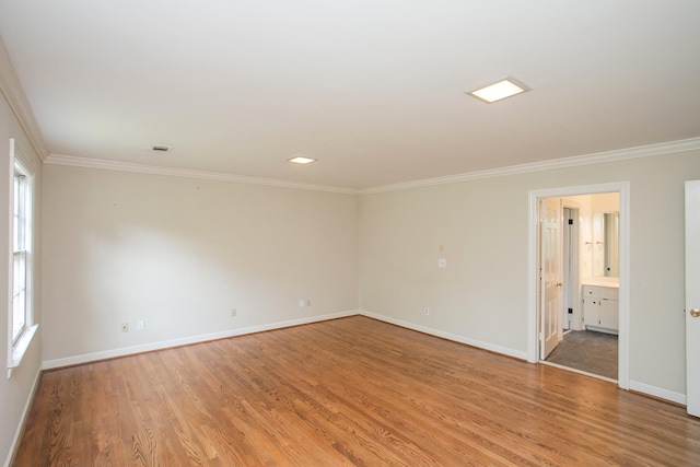 empty room featuring light hardwood / wood-style floors and ornamental molding