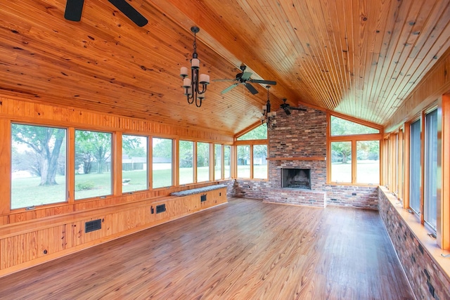 unfurnished living room featuring wood-type flooring, a brick fireplace, vaulted ceiling with beams, ceiling fan, and wooden ceiling