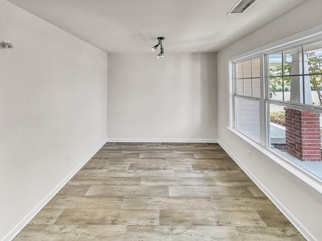 unfurnished dining area featuring wood finished floors, visible vents, and baseboards