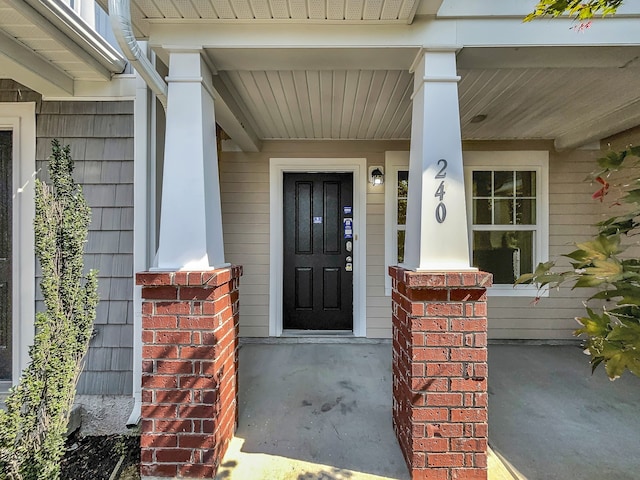 doorway to property featuring covered porch