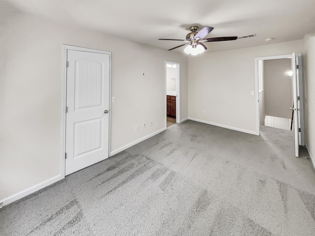 unfurnished bedroom with carpet, visible vents, and baseboards