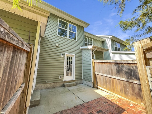 rear view of property with a patio area and fence