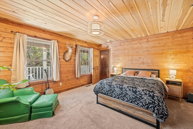 bedroom with wood walls, carpet floors, and wood ceiling