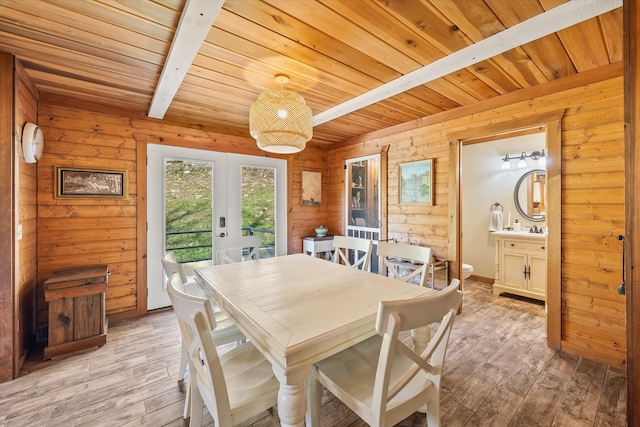 dining area with beamed ceiling, french doors, light hardwood / wood-style floors, and wooden ceiling