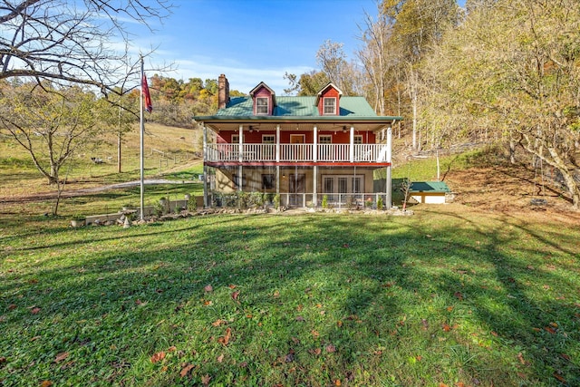 rear view of property featuring a yard