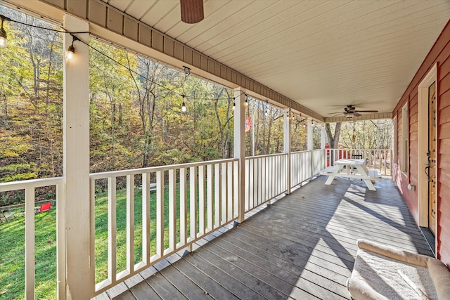 deck with a yard and ceiling fan