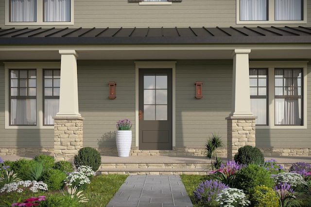 property entrance featuring a standing seam roof, covered porch, and metal roof