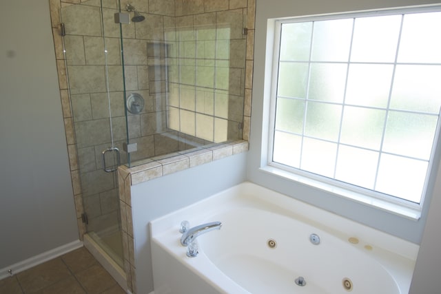 bathroom with separate shower and tub and tile patterned flooring