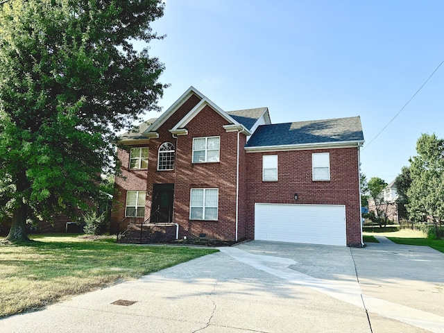 view of front of home with a garage and a front lawn