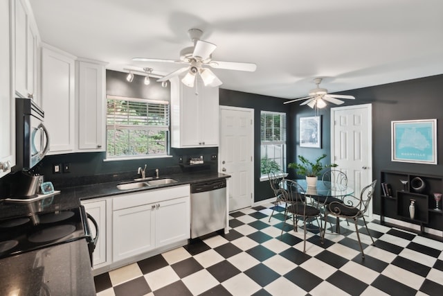 kitchen with track lighting, sink, ceiling fan, appliances with stainless steel finishes, and white cabinets