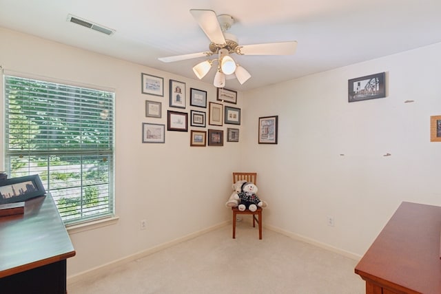 office area featuring ceiling fan and light carpet