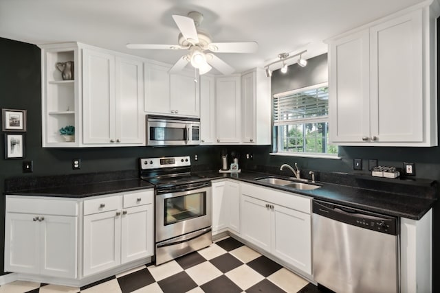 kitchen featuring white cabinets, ceiling fan, stainless steel appliances, and sink