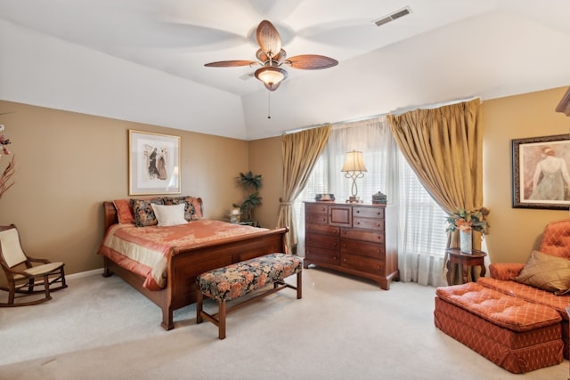 carpeted bedroom with ceiling fan and vaulted ceiling