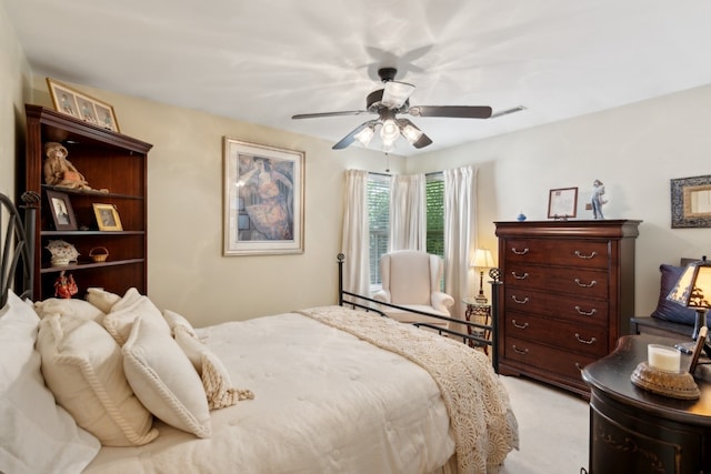 bedroom featuring light colored carpet and ceiling fan