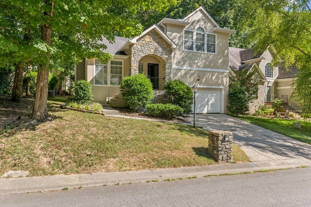 view of front of home with a front yard and a garage