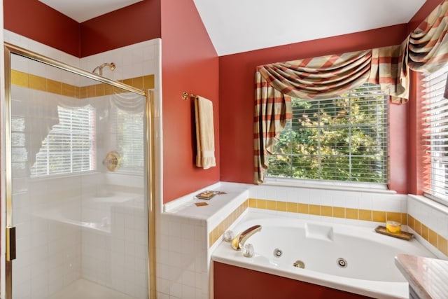 bathroom featuring a wealth of natural light and shower with separate bathtub