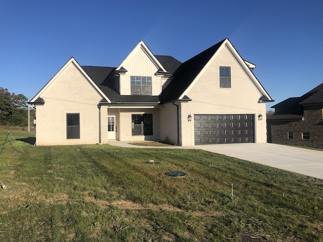 view of front of home featuring a front yard and a garage