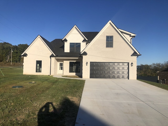 view of front of house with a front yard and a garage