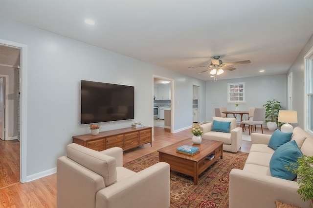 living room featuring ceiling fan and light wood-type flooring