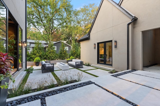 back of property featuring an outdoor hangout area, french doors, a patio area, and stucco siding