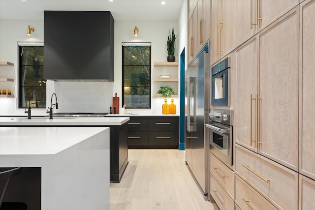 kitchen featuring light brown cabinets, appliances with stainless steel finishes, open shelves, and light countertops