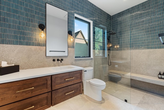 full bathroom featuring a walk in shower, toilet, vanity, tile walls, and tile patterned floors