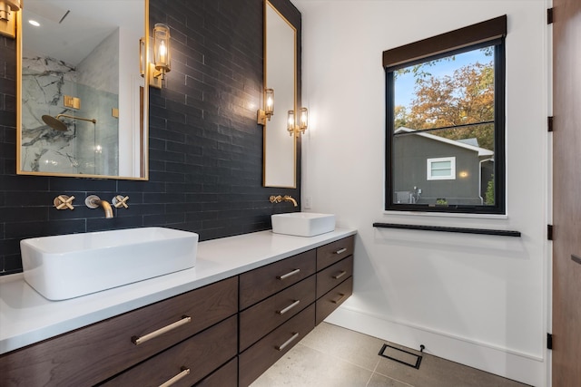 full bath with double vanity, tasteful backsplash, a sink, and a marble finish shower