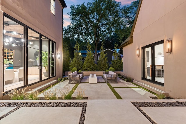 patio terrace at dusk with an outdoor living space