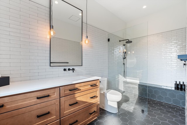 full bath featuring toilet, tile patterned floors, vanity, a walk in shower, and tile walls