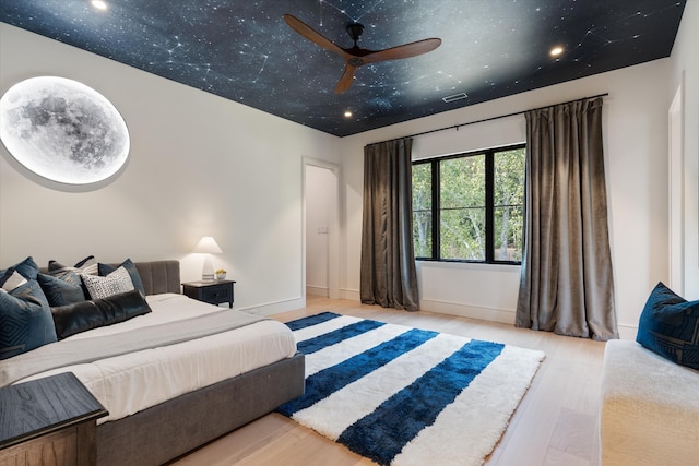 bedroom featuring baseboards and wood finished floors