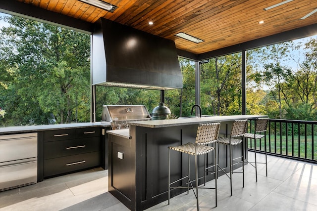 sunroom / solarium with wooden ceiling and a sink