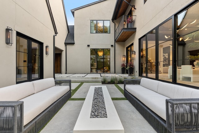 view of patio / terrace featuring a balcony, outdoor lounge area, and french doors