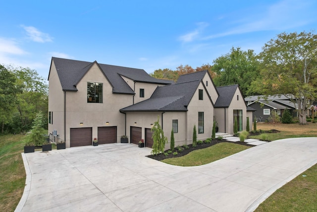 view of front facade featuring a garage, driveway, roof with shingles, stucco siding, and a front lawn