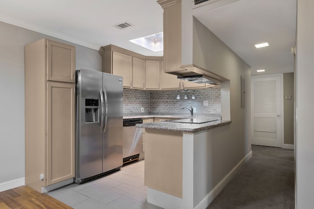 kitchen featuring tasteful backsplash, kitchen peninsula, light hardwood / wood-style floors, light brown cabinetry, and appliances with stainless steel finishes