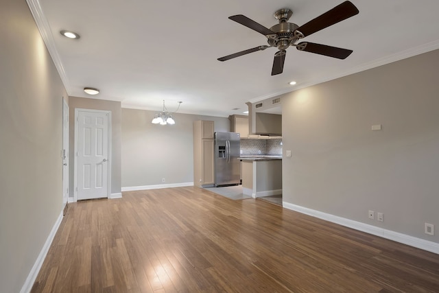 unfurnished living room featuring ceiling fan with notable chandelier, ornamental molding, and wood-type flooring