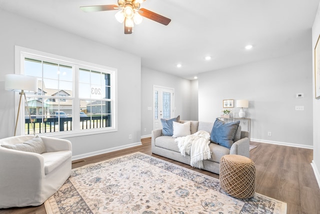 living room featuring a healthy amount of sunlight, ceiling fan, and hardwood / wood-style floors