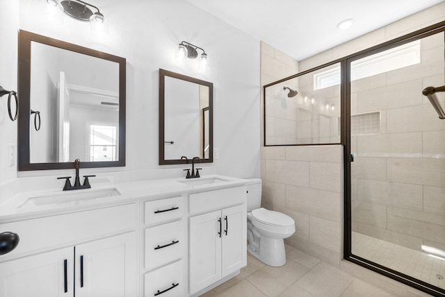 bathroom featuring vanity, tile patterned flooring, toilet, and an enclosed shower