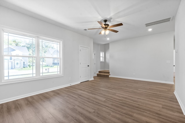 empty room with ceiling fan and dark wood-type flooring