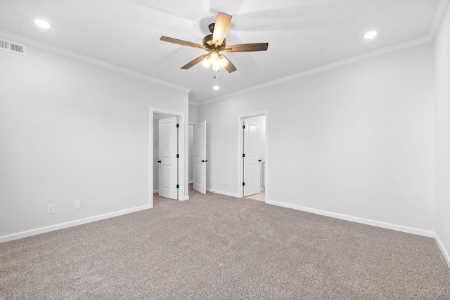 carpeted spare room with ceiling fan and ornamental molding