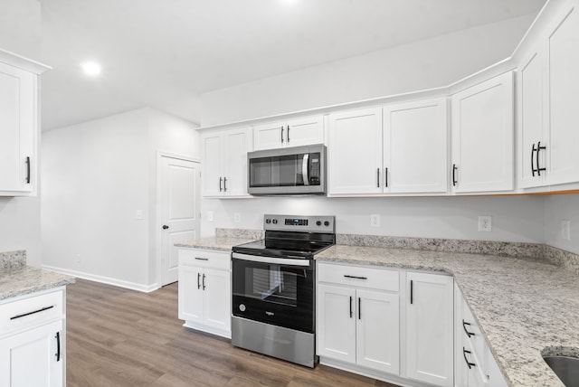 kitchen featuring light stone counters, white cabinets, stainless steel appliances, and dark hardwood / wood-style flooring