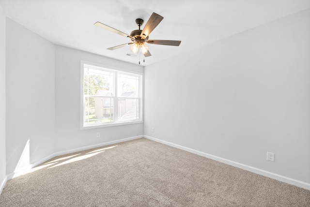 unfurnished room with ceiling fan and carpet